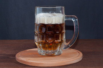 mug of beer on dark background