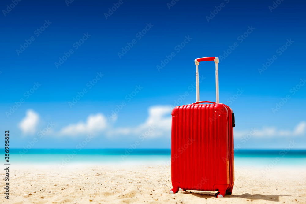 Sticker Summer red suitcase on beach and sea landscape. Free space for your decoration. Summer time 