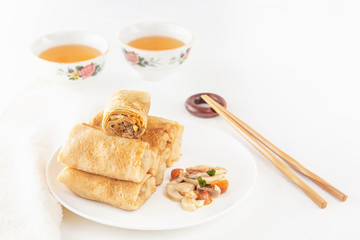 Traditional Chinese tortillas filled - bings in a plate with mushrooms on a white background, cups of tea. Copy space