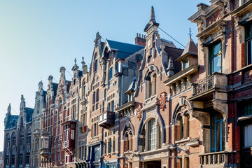 Fototapeta na wymiar Facades of buildings on a street of Ghent in Belgian Flanders