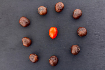 frame circle chestnut red tomato center on black dark background design culinary vegetable