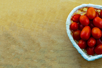 culinary design a bunch of cherry tomatoes mini vegetables in a white basket on a wooden background copy space