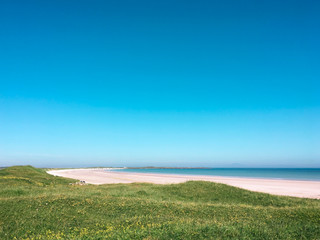Beach in the Inner Hebrides in the sun with turquoise sky