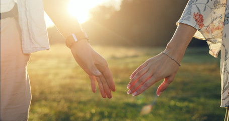 Loving couple holding hands close-up