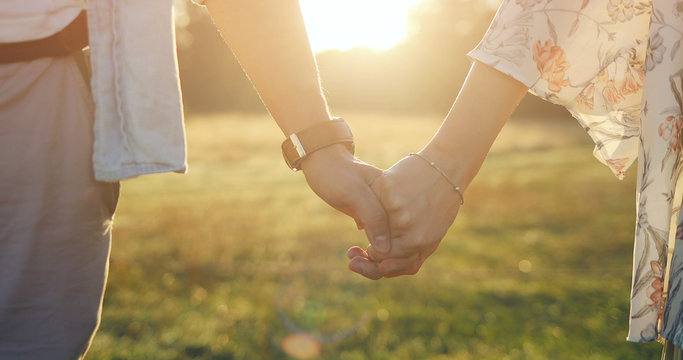 Loving couple holding hands close-up