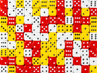 Background pattern of random ordered white, red and yellow dices