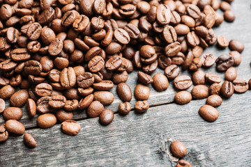 Coffee beans on the wooden table. Selective focus. Shallow depth of field.