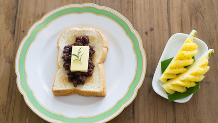 red bean toast with butter and fruits. ang butter bread. breakfast table