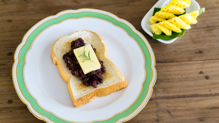 red bean toast with butter and fruits. ang butter bread. breakfast table