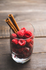 Frozen raspberry with cinnamon in glass. Selective focus. Shallow depth of field.