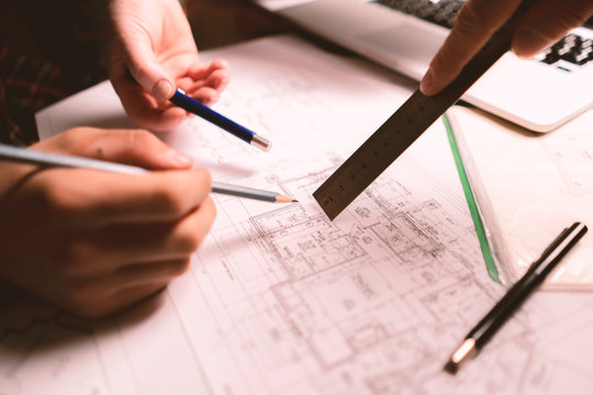 team of friendly architectors making a building plan