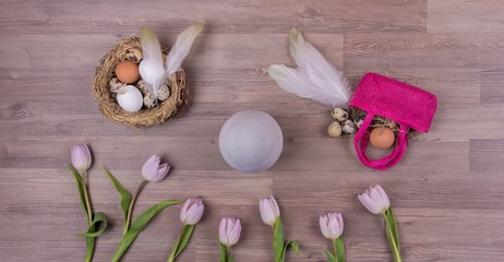 Easter holiday decoration panorama with eggs feathers bag tulips. Beautiful decoration easternest with egg flowers basket for traditional celebration in april. Handmade tinker luxury design bouquet