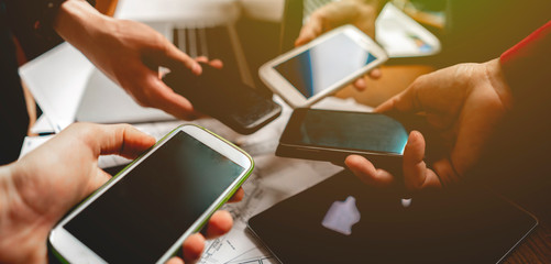 top view of peoples hands holding mobile phones