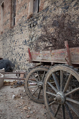 Fototapeta na wymiar Parked Wooden Cart, Traditional rural transport, Historic objects, Antique wooden wagon wheels, Colorful wooden cart, Turkish traditional wagon, Old brick wall