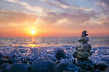 hareubang pebble reflection at sunset over the sea - zen and relaxation - obrazy, fototapety, plakaty