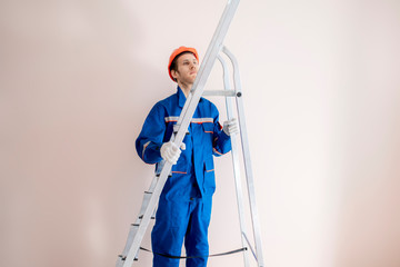 worker in blue uniform carry the ladder f