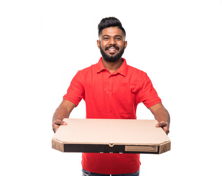 Delivery Concept: Handsome Pizza Delivery Man Courier In Red Uniform With Cap Holding Pizza Boxes Isolated On White Background