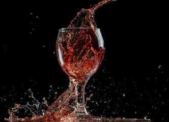 splash and flow from red wine in a glass, speed freeze