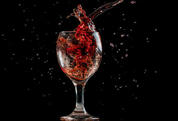 splash and flow from red wine in a glass, speed freeze