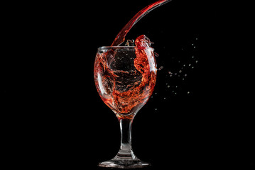 splash and flow from red wine in a glass, speed freeze