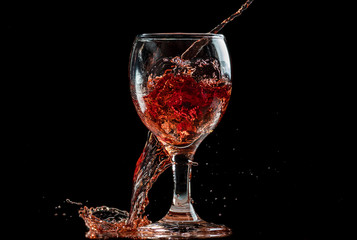 splash and flow from red wine in a glass, speed freeze
