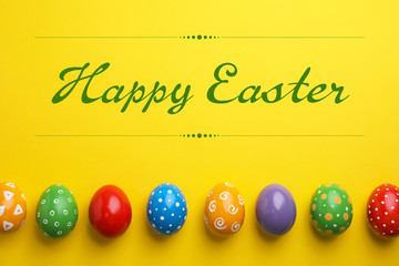 Decorated Easter eggs and space for text on color background, top view