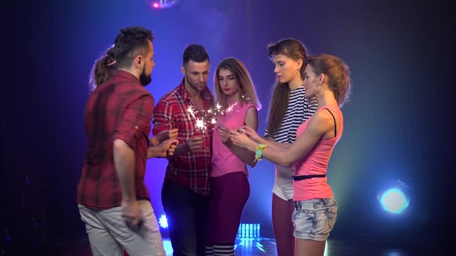 Couple in love at a disco with sparklers