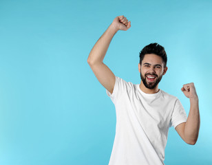 Fototapeta premium Portrait of happy young man on color background. Space for text