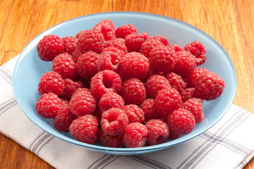 raspberries fruit in bowl like summer fruits and healthy food 