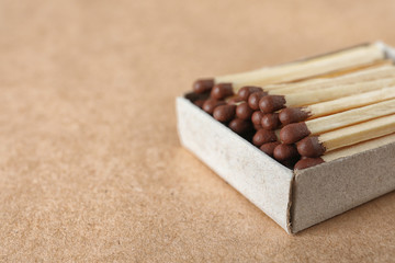 Open box with matches on craft paper, space for text
