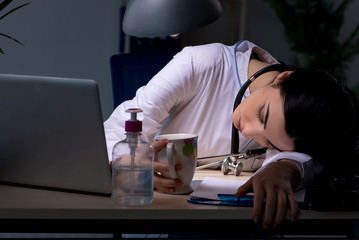 Young female doctor working at night shift