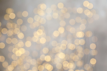 Blurred view of golden Christmas lights as background. Bokeh effect