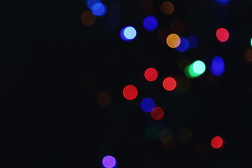 Beautiful colorful lights on dark background. Bokeh effect