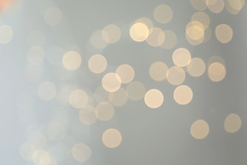 Blurred view of golden Christmas lights as background. Bokeh effect