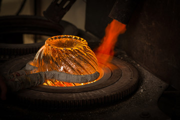 Glass making process. Workers body parts and tools