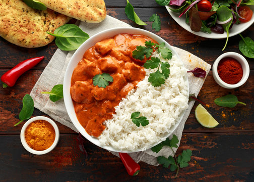 Chicken tikka masala curry with rice and naan bread