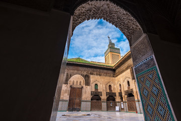 FES, MOROCCO - November 16, 2018: The minaret view and Inside interior of The Madrasa Bou Inania (...