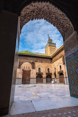 FES, MOROCCO - November 16, 2018: The minaret view and Inside interior of The Madrasa Bou Inania (...