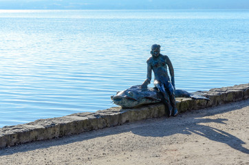 Woman with fish statue 1
