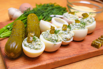 Deviled eggs with greens and pickles