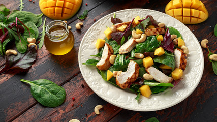 Grilled Chicken Mango salad with nuts and vegetables. Healthy food.