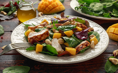 Grilled Chicken Mango salad with nuts and vegetables. Healthy food.