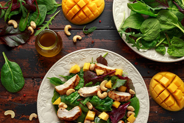 Grilled Chicken Mango salad with nuts and vegetables. Healthy food.