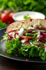 Doner kebab, fried lamb meat with vegetables and garlic sauce in turkish bread
