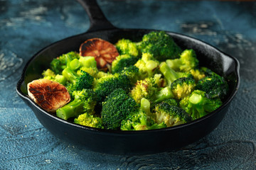 Fried broccoli in cast iron skillet, frying pan