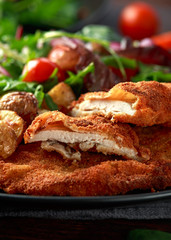 Homemade breaded pork schnitzel with roast potato and vegetables