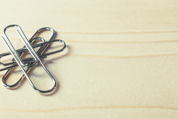 Close up of paper clip on wooden with copyspace