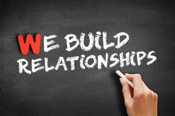 We Build Relationships text on blackboard, concept background