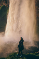 Man standing in front of the waterfall