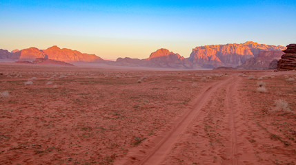 Fototapeta na wymiar Desert trail in Wadi Rum Jordan at sunset